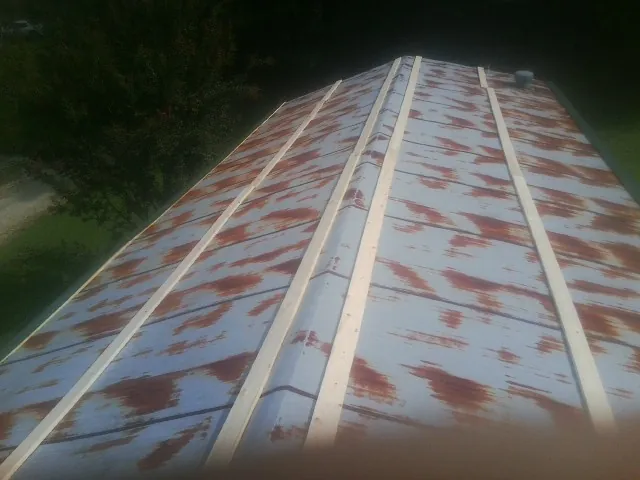 Rusted metal roof panels with new wood purlins before replacement — Storm Damage Roof Repair in Flagler by Roofing Brothers